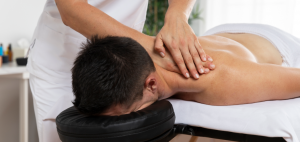 physiotherapist-massaging-patient-office-1